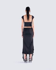 Let your sultry side shine in this sexy all-black fit 🖤 Featuring a black backless top, paired with a black ruffled maxi skirt for a look that will have you turning heads and taking names 🤤 Flirty Fitted Crop Top For Evening, Glamorous Evening Maxi Skirt For Summer, Flirty Stretch Crop Top For Evening, Flirty Evening Stretch Crop Top, Chic Ruffled Maxi Skirt For Evening, Elegant Backless Crop Top For Evening, Summer Evening Ruffled Maxi Skirt, Black Fitted Evening Crop Top, Flirty Ruffled Crop Top For Night Out