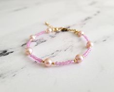 This gorgeous and dainty bracelet is made from high quality natural pink sapphires and 7 baby pink AAA grade freshwater pearls with all gold filled components that is tarnish resistant and suitable for everyday wear.  The length is 6.5 inches with 1 inch extension chain. Please message me if you need a customized size or without the extension chain, I need to confirm availability first as my supplies are very limited. Please note that while I try my best to capture the true colors of the bracele Elegant Pink Hypoallergenic Beaded Bracelets, Delicate Pink Pearl Bracelet As A Gift, Delicate Pink Pearl Bracelet With Round Beads, Elegant Pink Hypoallergenic Bracelet, Delicate Pink Pearl Bracelet As Gift, Delicate Pink Round Bracelets, Dainty Pink Pearl Bracelets, Delicate Pink Pearl Beaded Bracelet, Handmade Dainty Pink Pearl Bracelet