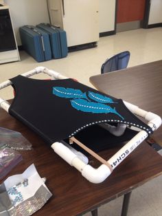 a black and blue umbrella sitting on top of a wooden table