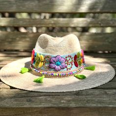 Check out our Handmade Straw Hat, your next go-to accessory for all things summer! This beauty is handcrafted with care in Mexico and made from breezy straw material, offering you the perfect combo of comfort and cool when the heat is on. Not to be missed, the hat features an eye-catching Peruvian embroidered band that adds a pop of color and wraps elegantly around the wide brim, giving it that extra flair. The floral embroidery on the band brings a lively bohemian vibe to the hat, making it a g Embroidered Straw Hat For Beach With Short Brim, Beach Sun Hat With Embroidered Short Brim, Embroidered Wide Brim Straw Hat For Beach, Embroidered Short Brim Beach Hat, Embroidered Sun Hat With Short Brim For Vacation, Artisan Beach Hats One Size, Embroidered Sun Hat With Curved Brim For Vacation, Artisan Beach Hat, Handmade Multicolor Flat Brim Panama Hat