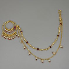 a gold necklace and earring set with pearls, garnets and rubles