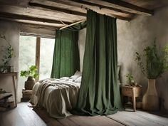 a bedroom with green drapes hanging from the ceiling