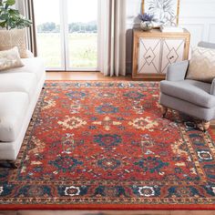 a living room filled with furniture and a large rug