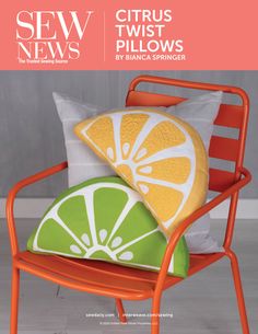 an orange chair with two pillows on top of it and a lime slice in the back