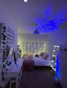 a bed room with a neatly made bed and lights on the ceiling