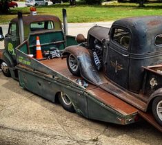 an old pick up truck is parked on the side of the road next to another car