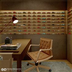 a chair sitting in front of a desk with a lamp on top of it next to a book shelf filled with books