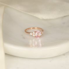 If you fancy peach sapphire rings, Thea is your gal! she is a one of a kind cluster ring that you can only find here at Rosados Box. #rings #engagementrings #weddingrings #rosadosbox #selftreat #rosegold #blush #champagne #sapphire #peach #gemstone #diamonds #cluster #oval #jewelry #finejewelry #gifts #sparkle #jewelry #finejewelry #gifts Classic Morganite Diamond Ring For Wedding, Classic Morganite Diamond Wedding Ring, Rose Gold Gia Certified Jewelry For Wedding, Rose Gold Gia Certified Wedding Jewelry, Gia Certified Rose Gold Wedding Diamond Ring, Morganite Rings Gia Certified For Anniversary, Morganite Pear-shaped Wedding Rings, Pear-shaped Morganite Wedding Jewelry, Pear-shaped Morganite Wedding Ring