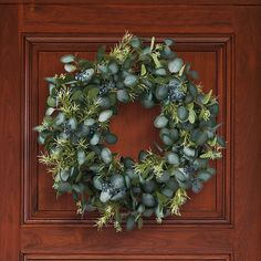 a wreath is hanging on the front door