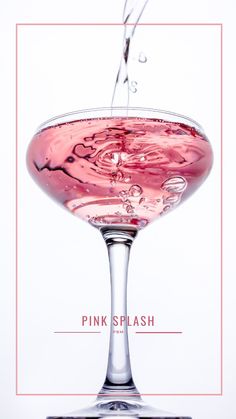 a pink drink being poured into a wine glass with the words pink splash on it