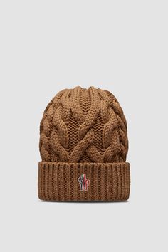 Taking you from the slopes to the city streets, this wool beanie is designed with warmth in mind. The heavy knit is part of the Moncler Grenoble collection. Winter Wool Knitted Beanie, Knitted Wool Beanie For Winter, Brown Wool Beanie For Winter, Winter Wool Beanie, Winter Wool Cable Knit Hat, Brown Wool Knitted Beanie, Brown Knitted Wool Beanie, Cozy Brown Wool Beanie, Wool Knitted Beanie Cap