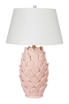 a pink ceramic table lamp with a white shade