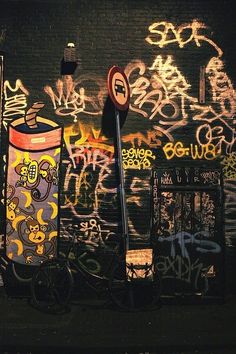 a bike parked next to a wall covered in graffiti