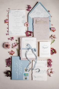 the wedding stationery is laid out on top of each other