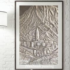 a drawing of a castle in the middle of a mountain range is featured on a white brick wall