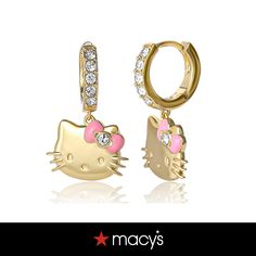 two hello kitty earrings with pink and white stones on the bottom, one in gold plated