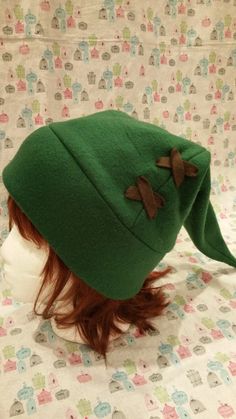 "Comes in green or olive green - please specify the color you want when ordering! Perfect for wearing during Halloween, conventions, cosplay, skiing/snowboarding, cold winter nights, or just for fun! Cute and comfortable! This hat is Adult sized - approximately 23\" around. For cleaning please spot clean only. Gentle hand wash if absolutely necessary. Need a different size? I take commissions! Feel free to email if you have any questions. Hats are made to order so please give about 1 to 2 weeks Fitted Warm Green Hat, Winter Cosplay Beanie Hat, Winter Costume Hat One Size, Green Winter Costume Hats And Headpieces, One Size Cosplay Hat For Winter, One Size Winter Cosplay Hats, Winter Cosplay Hats, Themed Winter Costume Hats And Headpieces, Themed Winter Hats For Cosplay