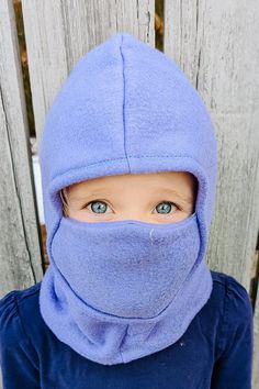 a young child wearing a blue ski mask