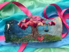 a felt bag with a tree and swing on it