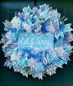 a blue and white wreath that says let it snow