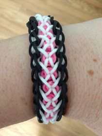 a close up of a person's arm wearing a bracelet with pink and white beads