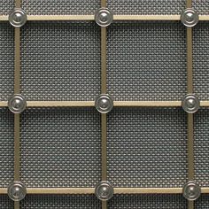 an array of metal squares and circles on a gray background with rivets in the center