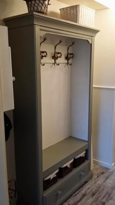 a gray cabinet with some hooks on it