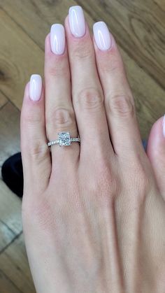 a woman's hand with a diamond ring on it