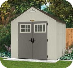 a large shed with two doors and windows on the side of it in a yard