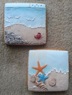 two cookies decorated with seashells and starfish are sitting on the floor next to each other