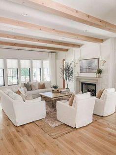 a living room filled with furniture and a fire place in the middle of a room