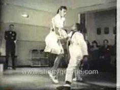 an old black and white photo of two people dancing