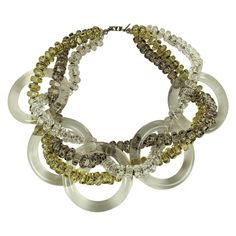 Fun Miriam Haskell Lucite Hoop Statement Necklace from the 1960's braided with crystal, pale olivine and pale smoke colored lucite beads with gilt metal spacers. Imposing scale and design. Signed Miriam Haskell. 1960's USA. 15.5" x 2.25" wide. Costume Jewelry With Polished Multi-strand Beads, Multi-strand Beaded Costume Jewelry Necklace, Vintage Multi-strand Jewelry With Large Beads, Vintage Miriam Haskell Jewelry, Miriam Haskell Earrings, Miriam Haskell, Fabulous Jewelry, Multi Strand Necklace, Multi Strand