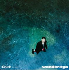 a man sitting on the ground in front of a blue background with words that read crush and wonder