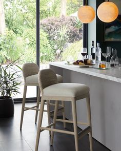 two bar stools sitting in front of a counter