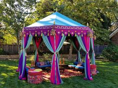 a colorful tent set up in the grass