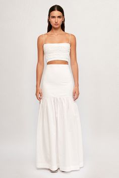 DESCRIPTION Mottled Crop - USD 259.00 Super fine spaghetti straps lead to a classic, square neckline in this classic with a twist. Cut from lightweight white cotton, the Mottled Crop stops just shy of the navel and features panels of shirring and a raised, flower-like texture. Wear yours with the matching maxi skirt. Color: White Heat Hip Hugging Maxi - USD 359.00 A must for every capsule closet, this bright white maxi skirt fits snug through the hips before falling into a full-length, softly pl Maxi Skirt Fits, Maxi Skirt White, 2025 Trends, White Maxi Skirt, Capsule Closet, White Maxi Skirts, White Heat, Skirt Fits, Skirt White