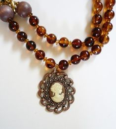 "I designed this funky and fun one-of-a-kind necklace that I named \"Picture Perfect\".  It is made from vintage 1950's gold tone chain, plastic tortoise shell beads and 2 wooden beads from the 1950's.  The centerpiece charm is a gorgeous copper colored metal vintage brooch with a hand painted cameo displayed in the center.  The length is 20 1/2\".  This necklace is so versatile.  You can wear it with jeans and a t-shirt or dress it up with a skirt or dress." Pewter Pendant, Sherman Oaks, Cameo Necklace, Celtic Cross, Christmas Gift Jewelry, Mens Pendant, Shell Beads, Copper Color, Larp