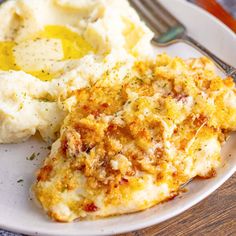 a white plate topped with mashed potatoes and chicken