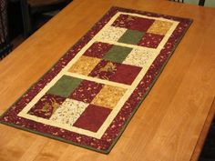 a wooden table with a quilted runner on it