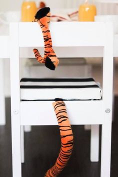 a stuffed animal sitting on top of a white chair