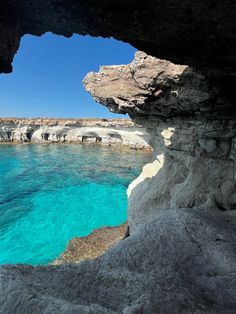 the water is crystal blue and clear in this cave near an island with white cliffs