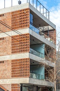 a tall brick building with balconies on the sides