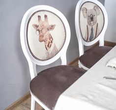 two chairs with giraffes painted on them