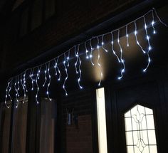 some lights are hanging from the side of a building