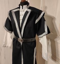 Kaftan for men with trim decoration. The pattern of the trim may differ from the photo!  Recommended also for LARP and reenactment events. Made with rustic fabric. It is made customized for every customer! Please note that above 90 kg/200 lbs for women and above 120 kg/260 lbs for men our products are made with an extra fee. Please order this listing as an addition: https://www.etsy.com/listing/1562690891/extra-cost-for-extra-size-production?click_key=8094f62d573a9ac48333de812216d36c4cc4ac02%3A1 Warrior Costumes For Medieval Festivals, Traditional Fitted Medieval Costume Dress, Traditional Fitted Medieval Dress For Costume Party, Historical Costumes For Medieval Festivals Costume Party, Traditional Costumes For Costume Party And Cosplay Events, Medieval Costumes With Historical Design For Cosplay, Medieval Costume For Fantasy Events, Medieval Cosplay Costume With Historical Design, Traditional Medieval Dress For Ceremonial Occasions