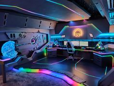 a futuristic office with neon lights on the walls