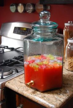 a glass jar filled with liquid sitting on top of a counter next to a stove