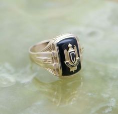 14K Yellow Gold Chelmsford High School Class Ring, 1937, black onyx stone, size 9.25, weight 6.7 grams Stock # BB86R35 This listing contains photographs of the actual item you will receive. Our items are in excellent condition with little or no signs of wear and many are one of a kind pre-owned estate finds. Please look closely at the pictures in this listing as they are part of the product description. Please read the description, as any imperfections or condition comments will be included. We Classic Onyx Signet Ring With Black Enamel, Black Heirloom Jewelry For Collectors, Classic Black Engraved Ring Stamped 14k, Black Engraved 14k Gold Ring, Black 14k Gold Hallmarked Engraved Ring, Black 14k Gold Engraved Ring, Heirloom Black Round Signet Ring, Heirloom Black Polished Finish Jewelry, Black Heirloom Jewelry With Polished Finish