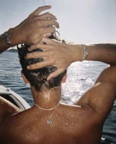 the back of a man's head as he washes his hair in the water